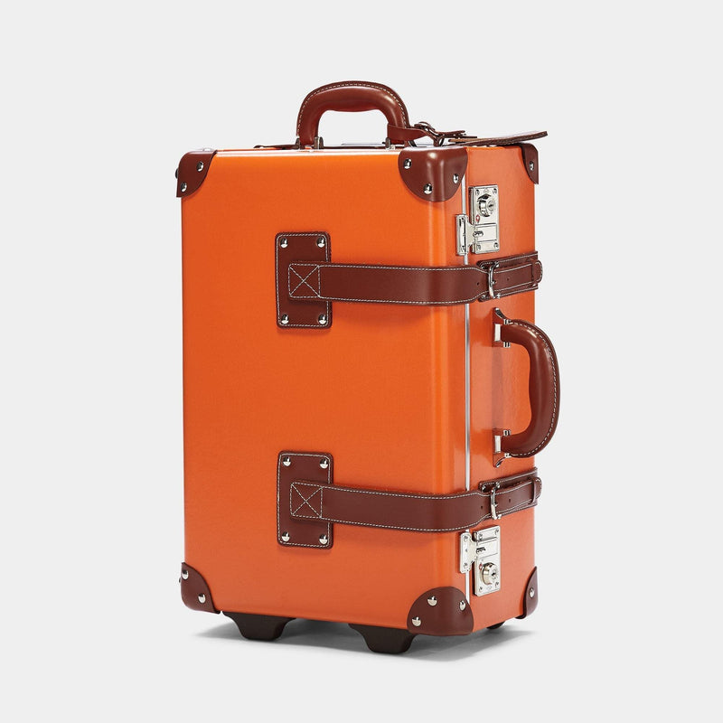 Angled product view of the carry-on Anthropologist leather suitcase in orange