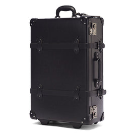 Angled product view of the stowaway Industrialist fibreboard suitcase in black