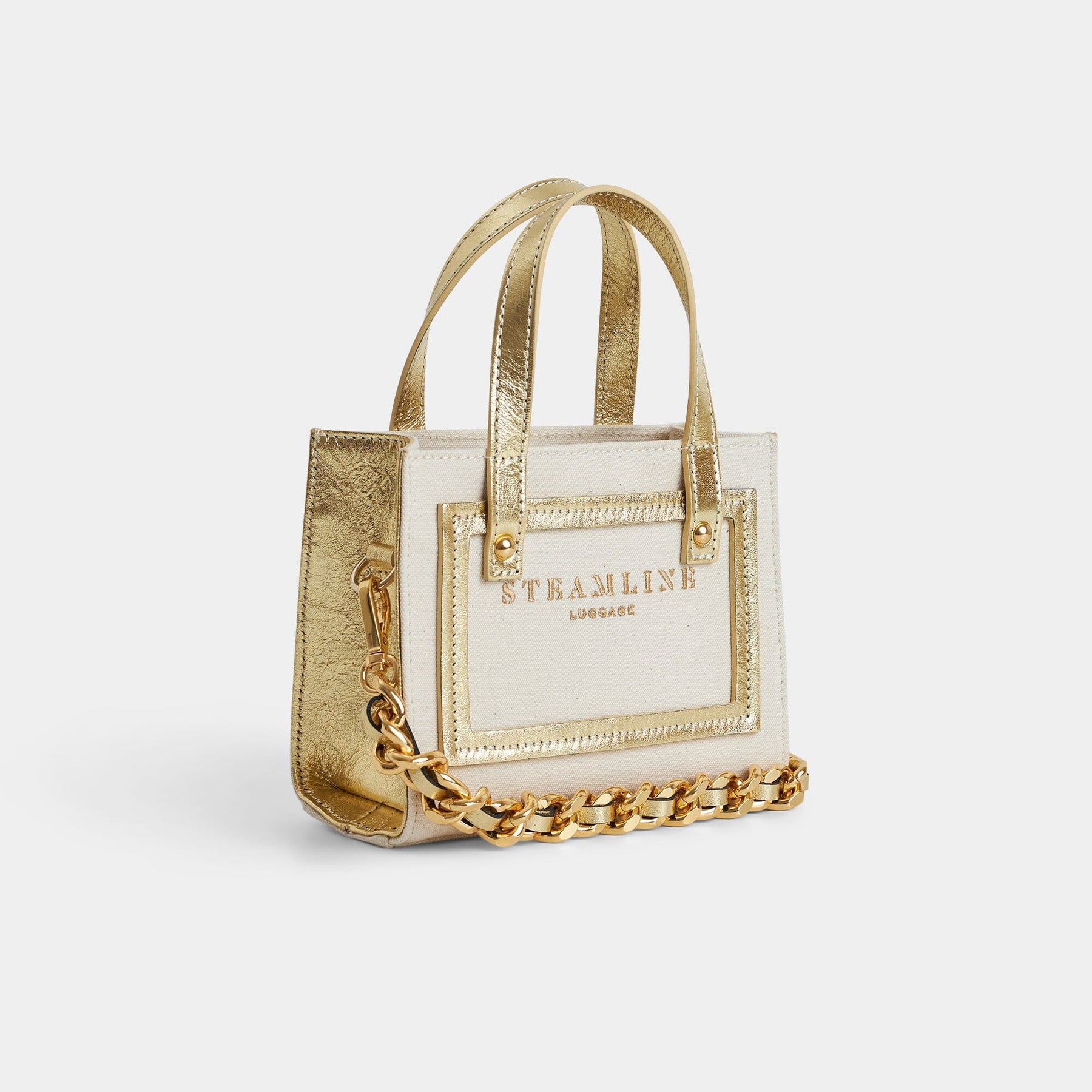 Angled product  view of the Navigator leather mini tote in ecru with gold accents, trims and chain strap