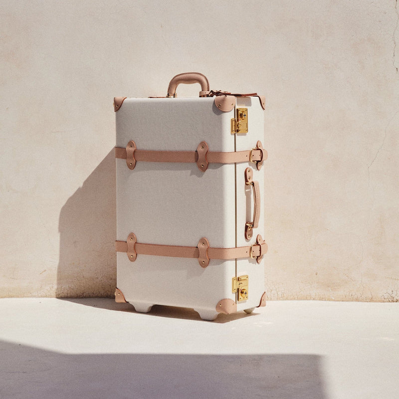 Lifestyle image of the stowaway Sweetheart fibreboard suitcase in cream