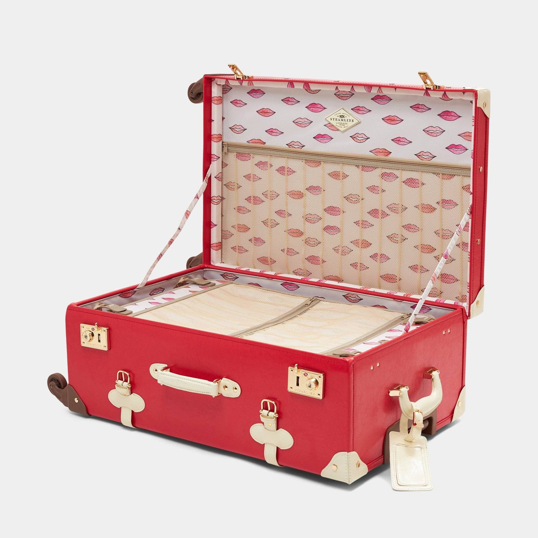 Open product view of the check-in spinner Entrepreneur vegan leather suitcase in lipstick red with lip print lining and white vegan leather luggage tag