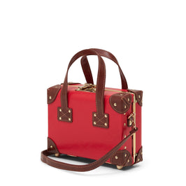 Angled product view of the mini Entrepreneur vegan leather suitcase in red with shoulder attachment strap