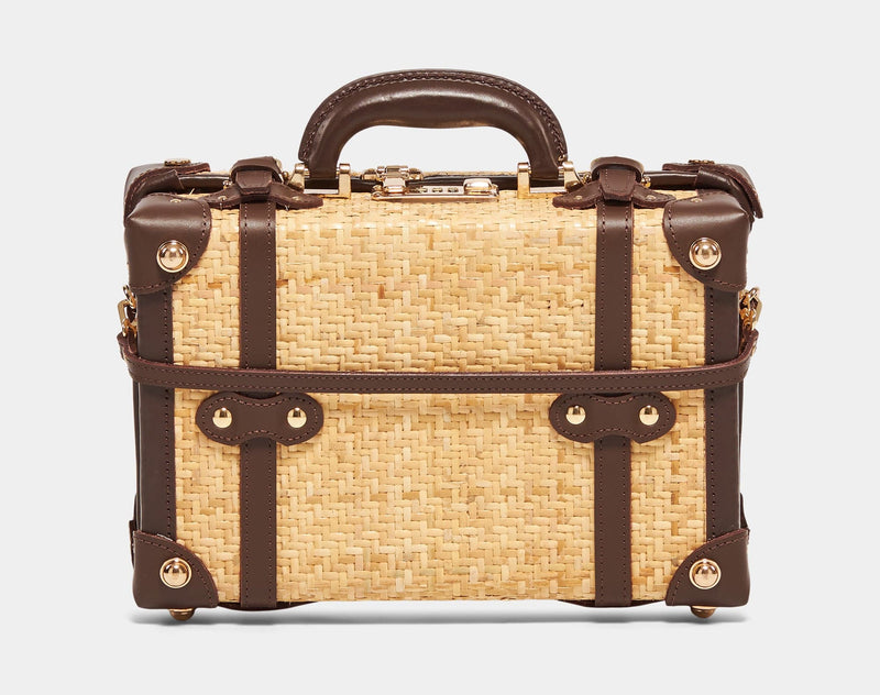 Back product view of the vanity Explorer rattan suitcase in natural wicker body and brown trims with detachable suitcase strap