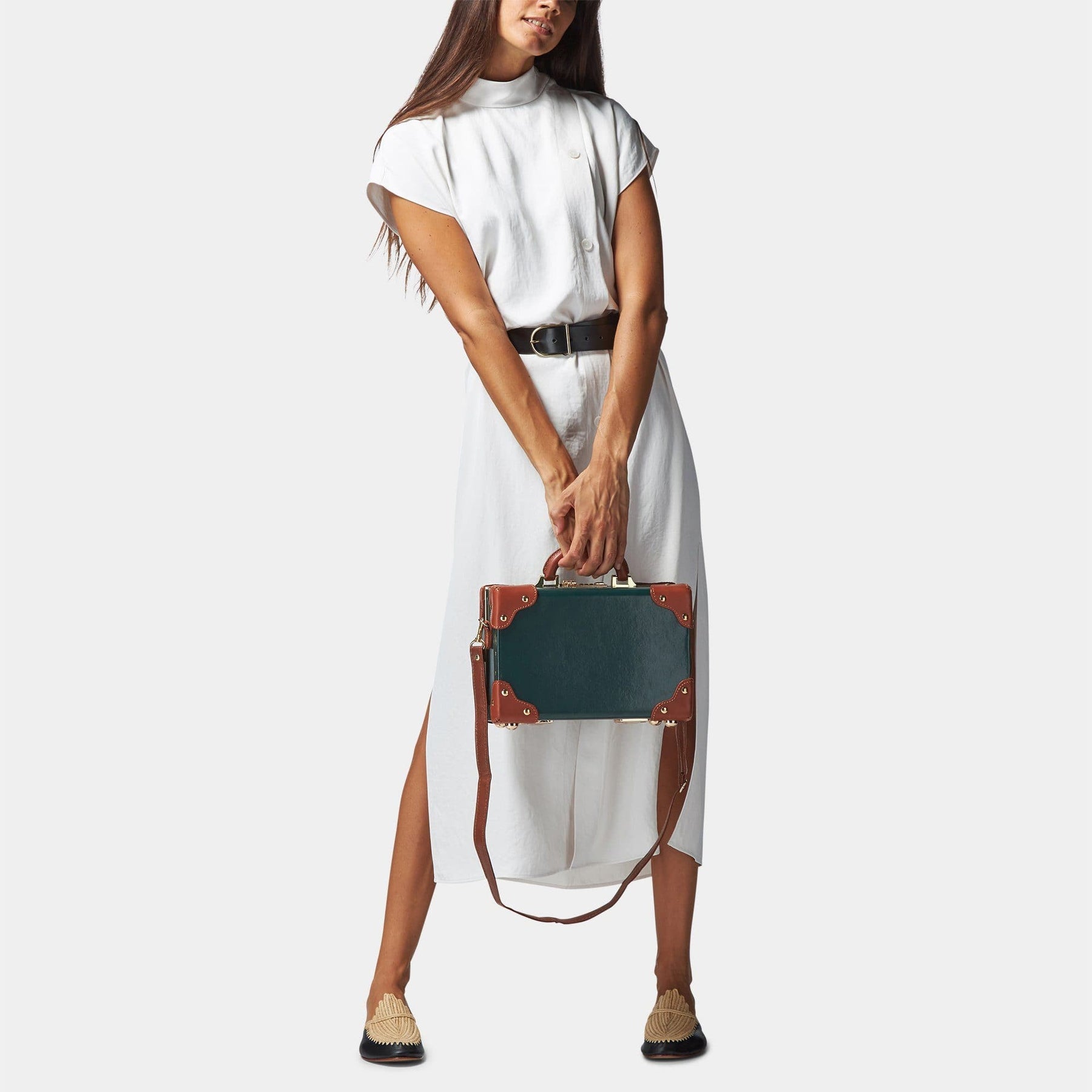 Model with the vanity Diplomat leather suitcase in hunter green with shoulder attachment strap