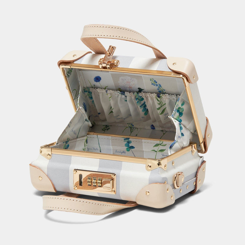 Open product view of the mini Illustrator fibreboard suitcase in blue-stripe with wildflower print lining