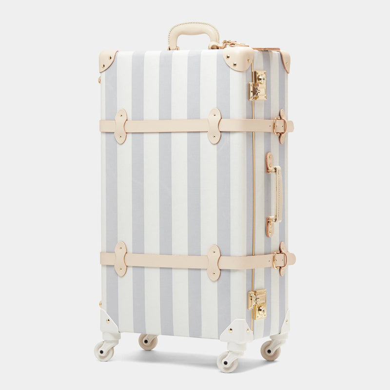 Angled product view of the check-in spinner Illustrator fibreboard suitcase in blue-stripe 