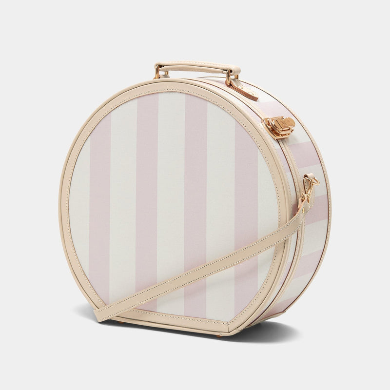 Angled product view of the large hatbox Illustrator fibreboard suitcase in  pink-stripe with shoulder attachment strap