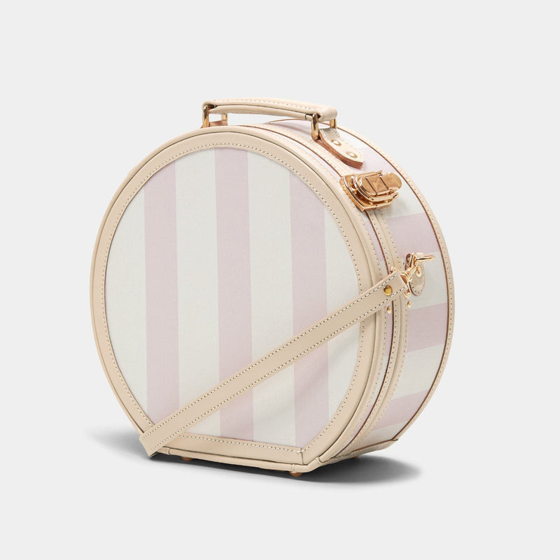 Angled product view of the small hatbox Illustrator fibreboard suitcase in  pink-stripe with shoulder attachment strap