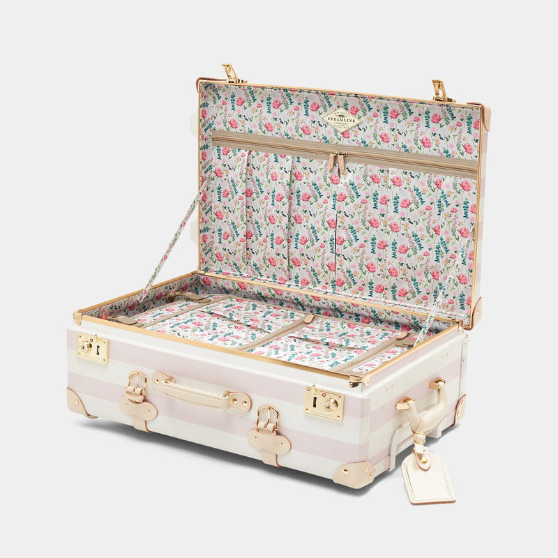 Open product view of the stowaway Illustrator fibreboard suitcase in stripe pink with wildflower printed lining
