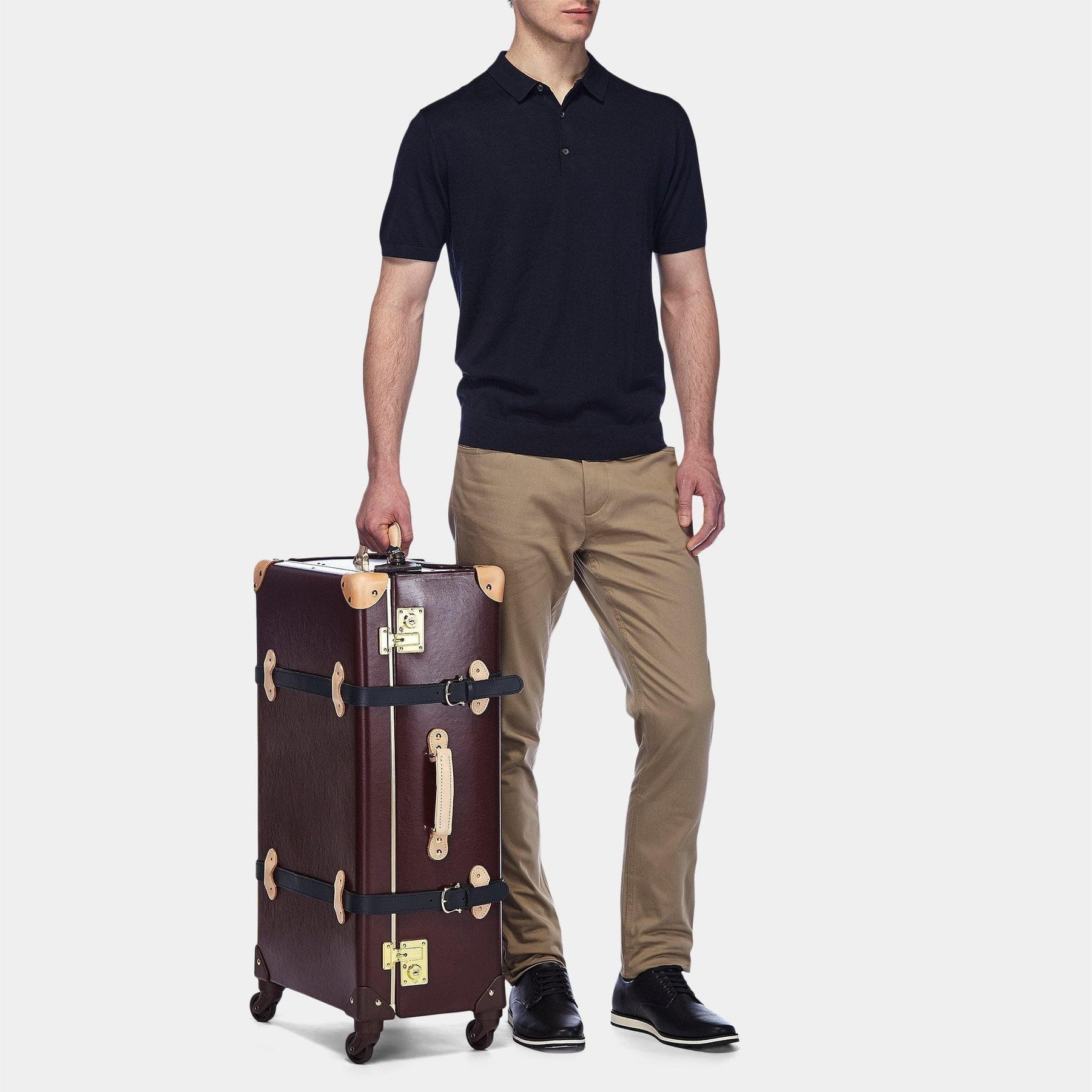Male model with the check-in Architect leather suitcase in burgundy