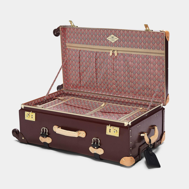 Open product view of the check-in Architect leather suitcase in burgundy with art-deco printed lining and black leather luggage tag