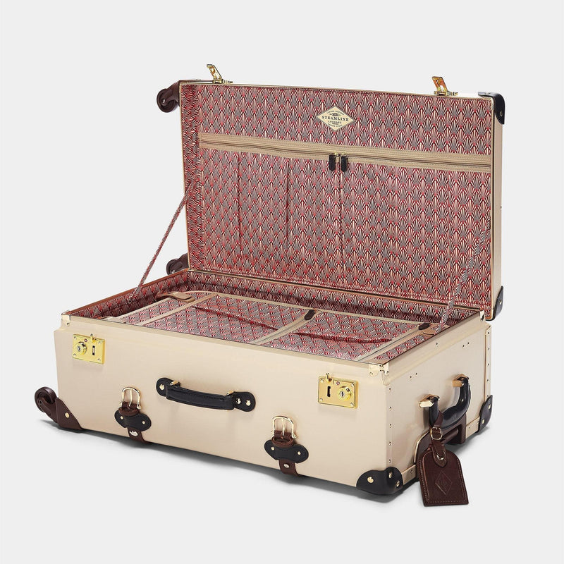 Open product view of the check-in Architect leather suitcase in cream with art-deco printed lining and brown leather luggage tag