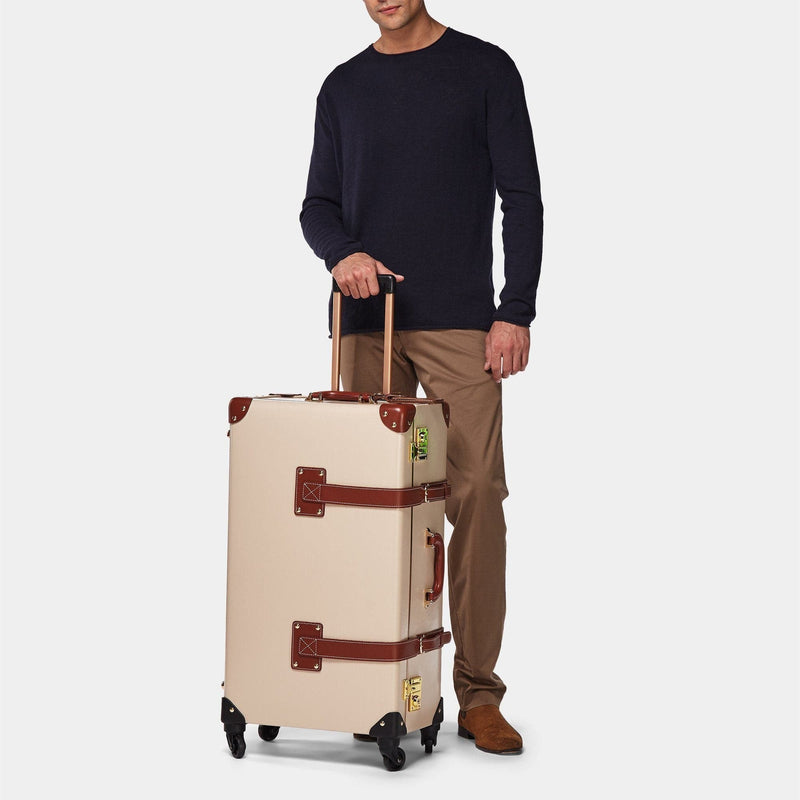Male model with the check-in Diplomat leather suitcase in cream with raised handle