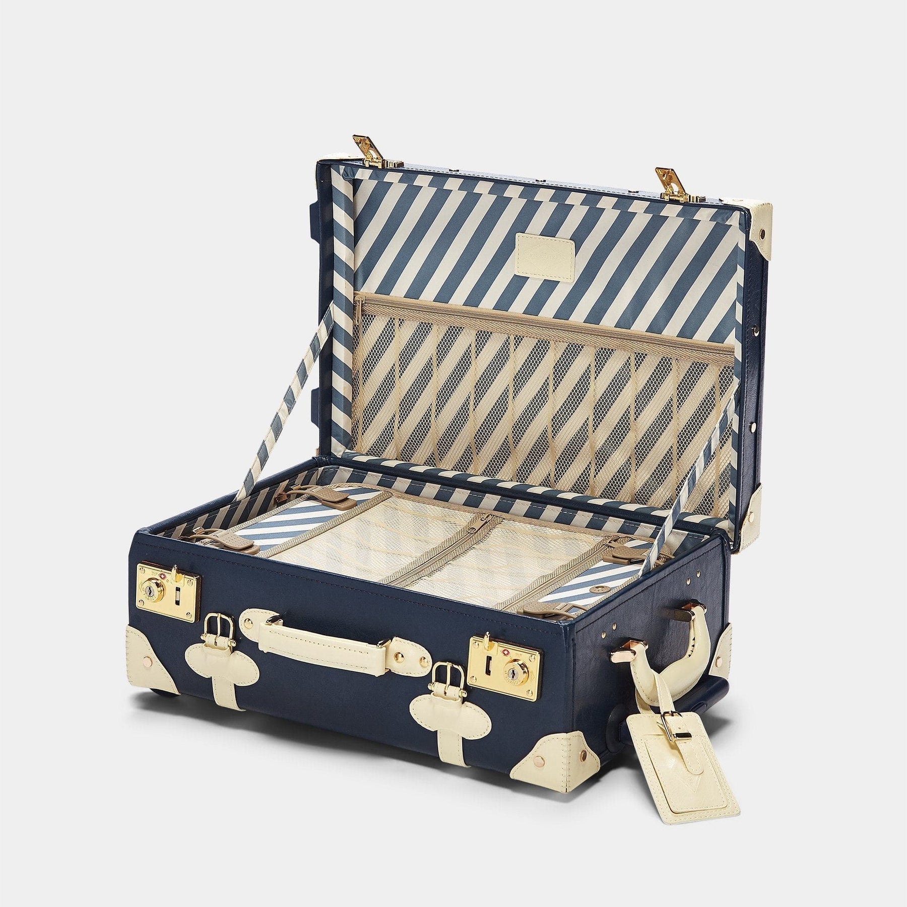 Open product view of the carry-on Entrepreneur vegan leather suitcase in navy with blue-white stripe print lining and white vegan leather luggage tag