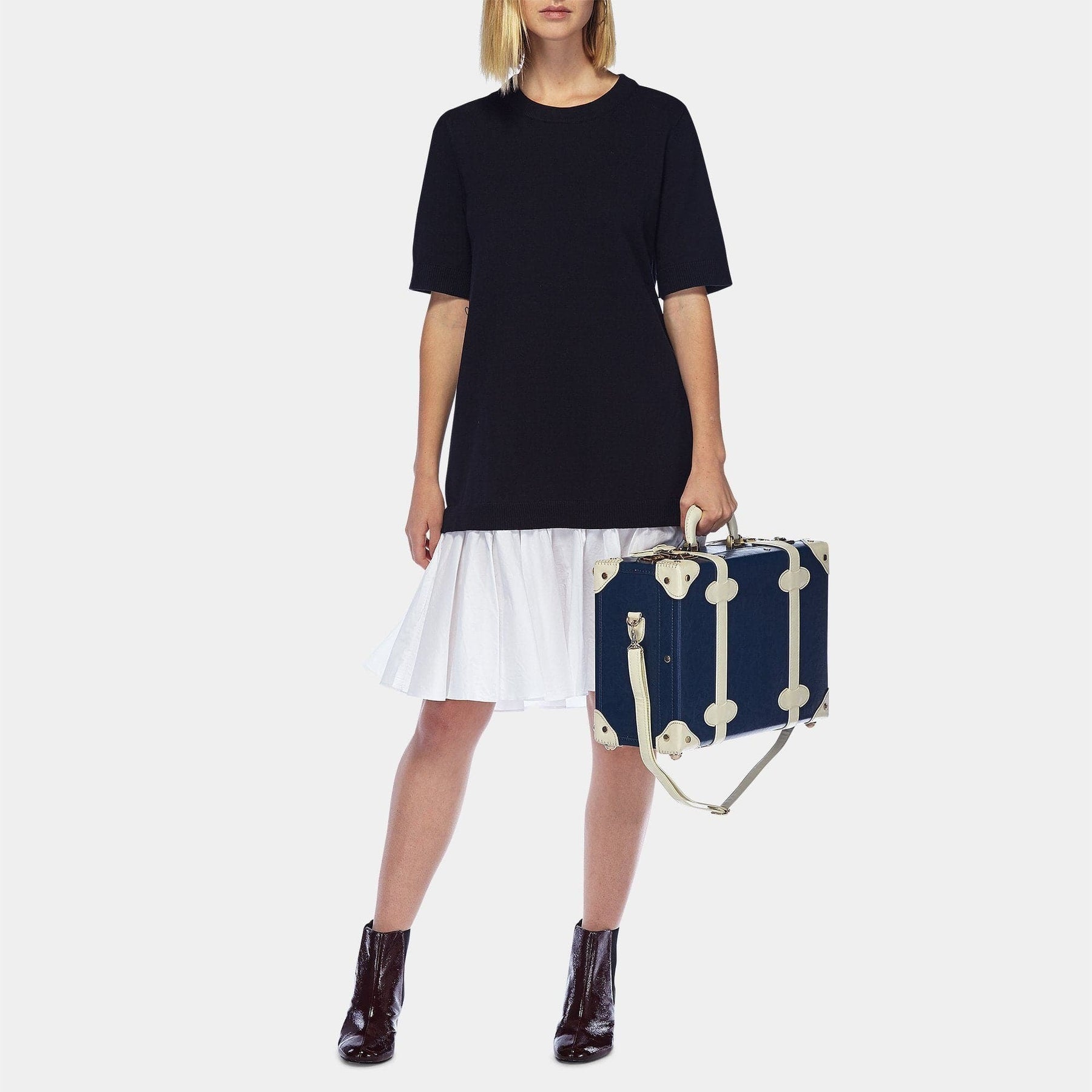 Model with the overnighter Entrepreneur vegan leather suitcase in navy with shoulder attachment strap
