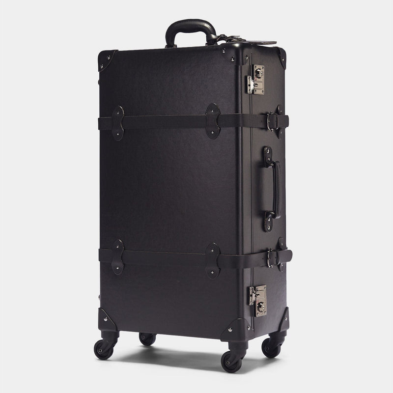 Angled product view of the check-in spinner Industrialist fibreboard suitcase in black