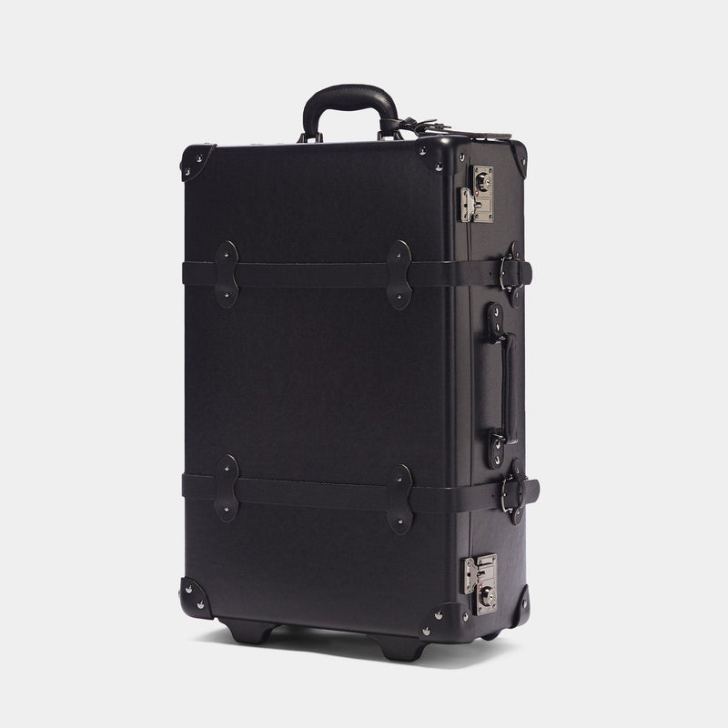 Angled product view of the stowaway Industrialist fibreboard suitcase in black
