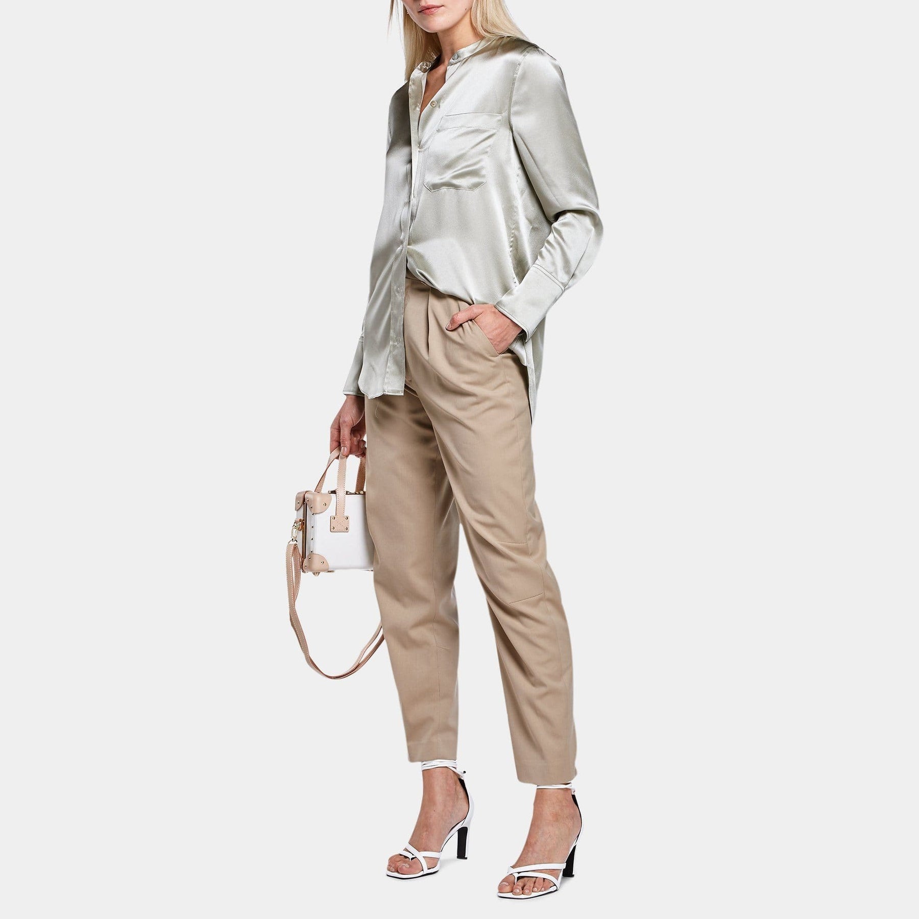 Model with the mini Sweetheart fibreboard suitcase in cream with shoulder attachment strap