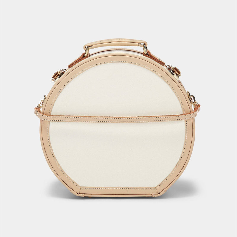 Product view of the small hatbox Sweetheart fibreboard suitcase in cream with detachable suitcase strap