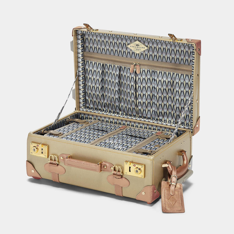 Open product view of the carry-on Alchemist vegan leather suitcase in gold with art-deco print lining