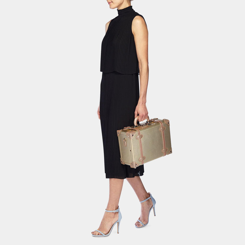 Model with the briefcase Alchemist vegan leather suitcase in gold