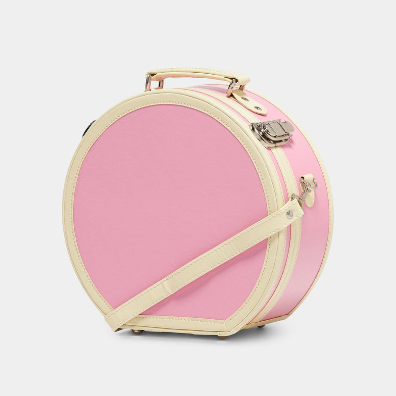 Angled product view of the small hatbox Entrepreneur vegan leather suitcase in pink with shoulder attachment strap