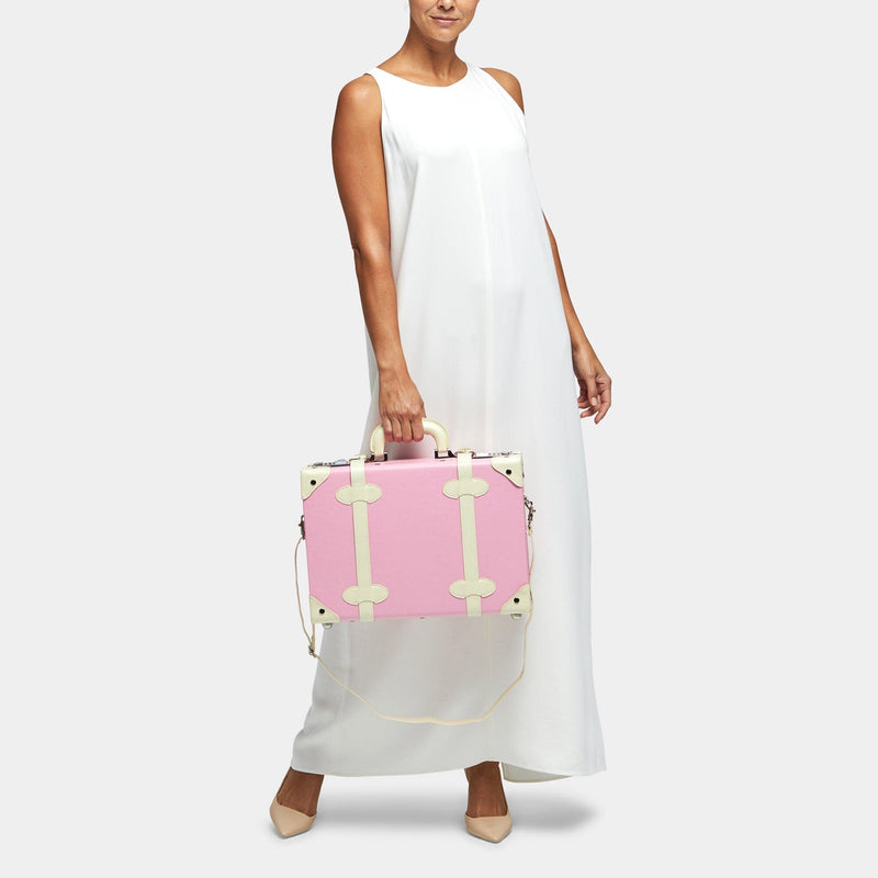 Model with the overnighter Entrepreneur vegan leather suitcase in pink with shoulder attachment strap